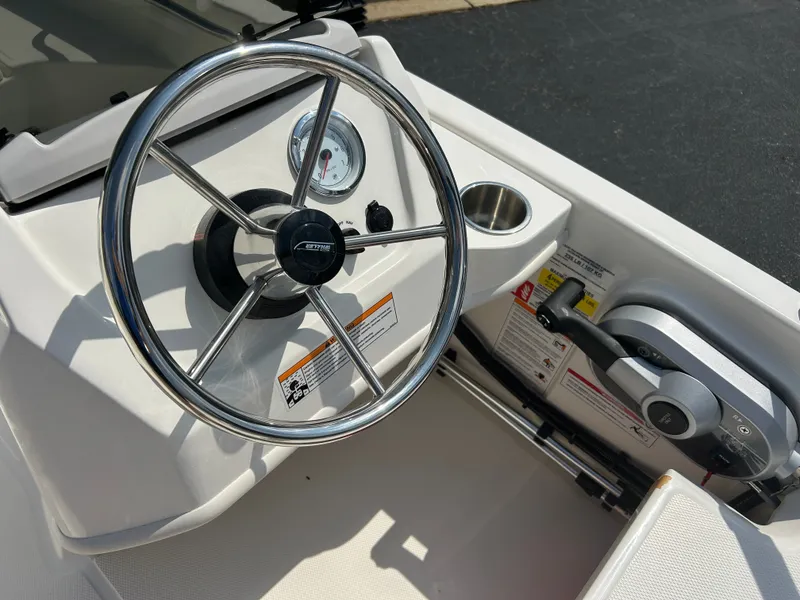 Slide: The Image of Close-up of a Boston Whaler 130 Super Sport helm with steering wheel and instruments. - 7
