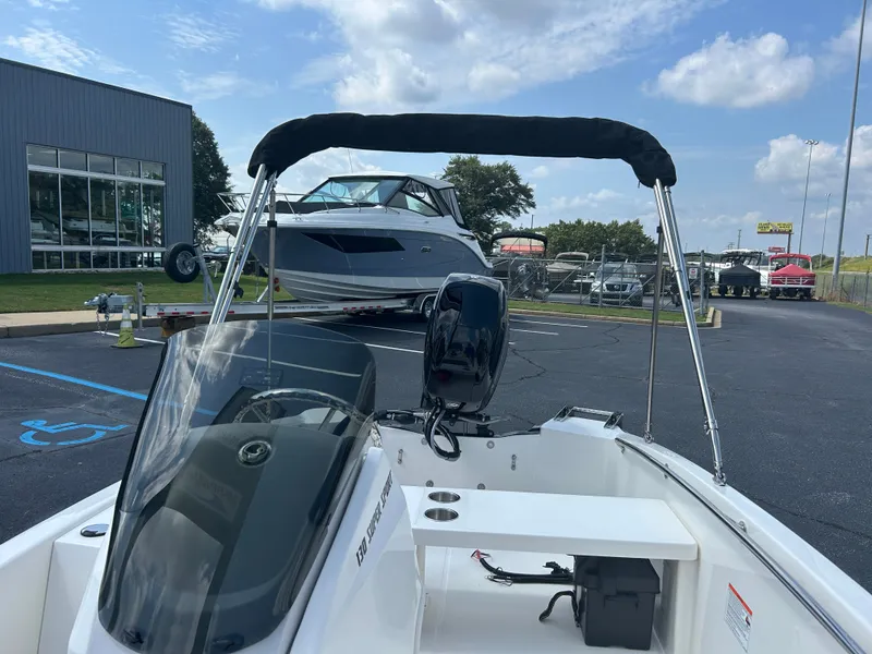 Slide: The Image of The image shows a 2027 Boston Whaler 130 Super Sport boat with a black motor. - 14