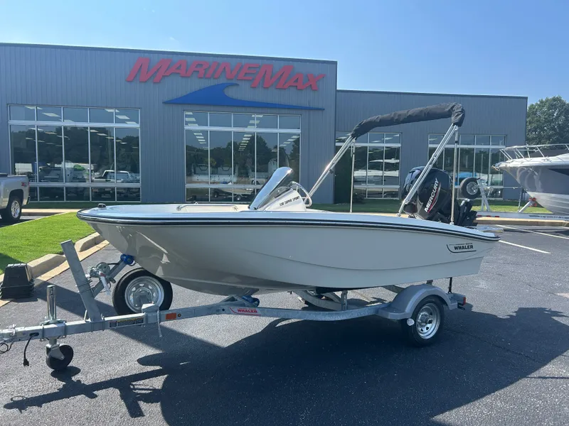 Slide: The Image of A 2027 Boston Whaler 130 Super Sport on a trailer in front of a MarineMax building. - 1