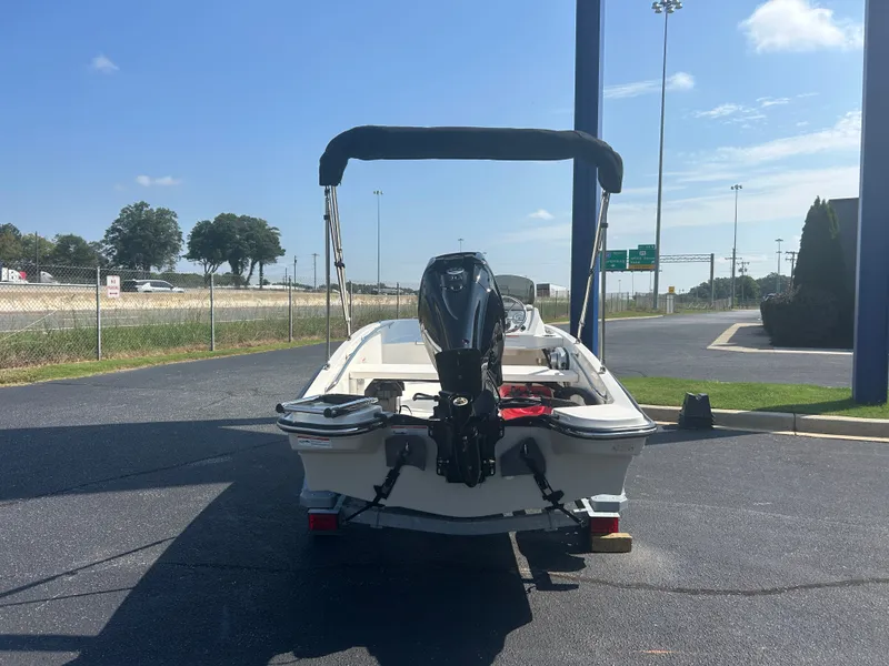 Slide: The Image of A 2027 Boston Whaler 130 Super Sport is parked. The outboard motor is visible. - 3