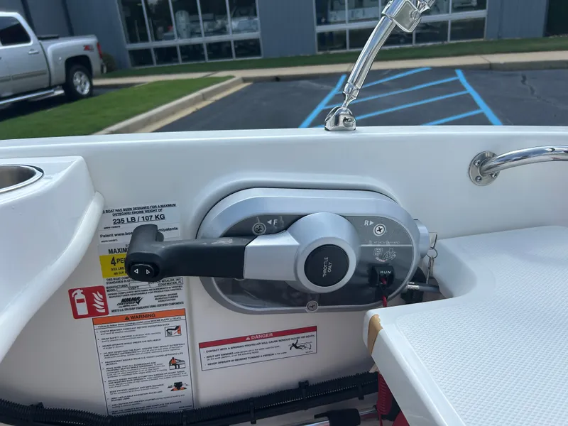 Slide: The Image of Close-up of the throttle control on a 2027 Boston Whaler 130 Super Sport, with instructions and warnings. - 8