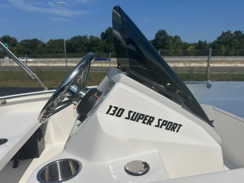 Slide: The Image of The image shows the helm of a Boston Whaler 130 Super Sport with a shiny steering wheel. - 4