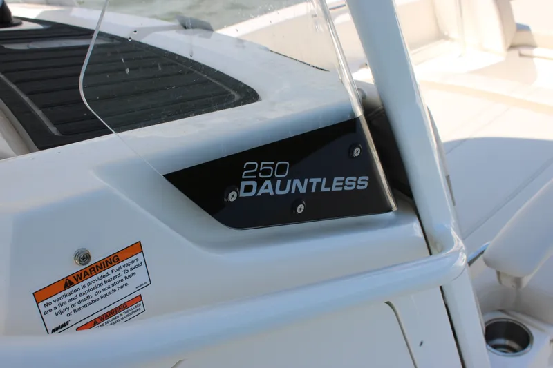 Slide: The Image of Close-up of the Boston Whaler 250 Dauntless with warning label and model name. - 15