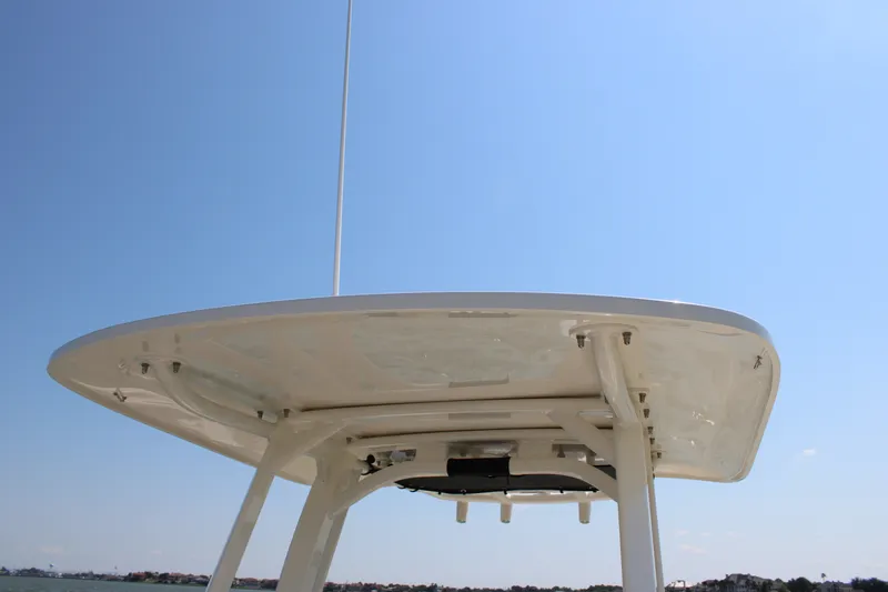 Slide: The Image of The image shows the T-top of a 2027 Boston Whaler 250 Dauntless under a clear blue sky. - 18
