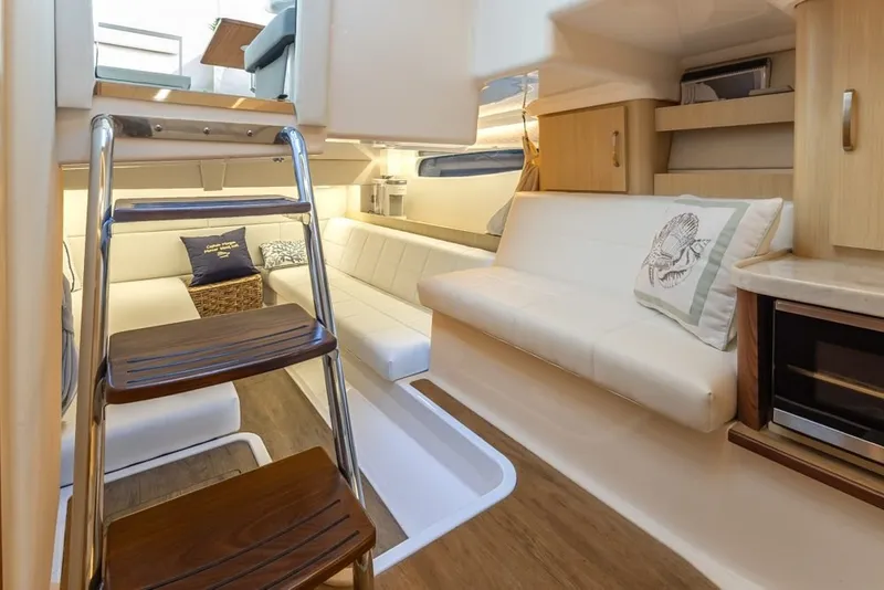 Slide: The Image of Luxurious interior of 2024 Regal 36 Grande Coupe yacht with elegant seating and modern design. - 12