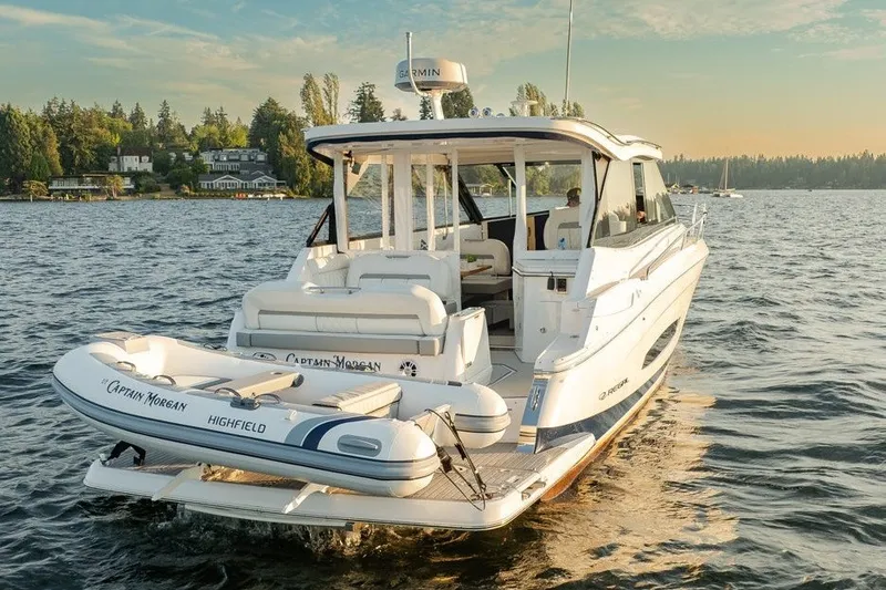 Slide: The Image of 2024 Regal 36 Grande Coupe cruising on a serene lake at sunset. - 23