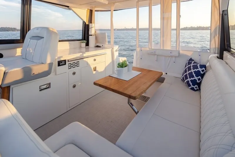 Slide: The Image of Luxurious interior of 2024 Regal 36 Grande Coupe yacht with elegant seating and scenic water view. - 5