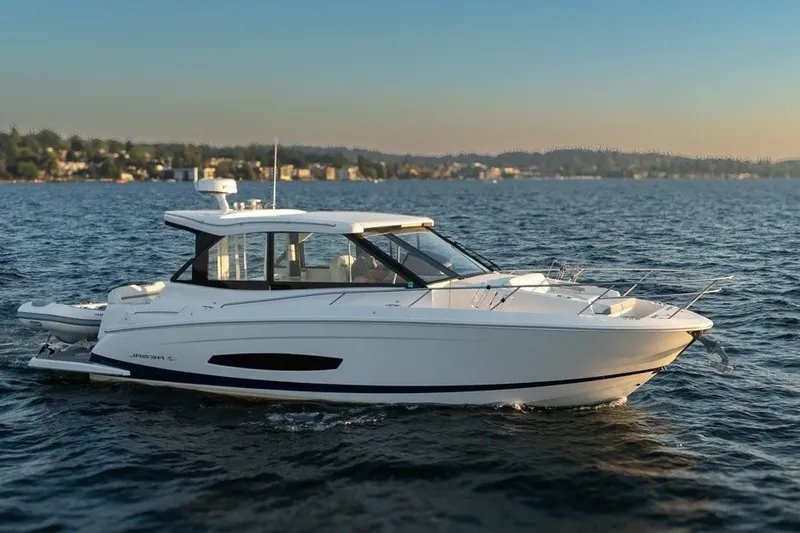 The Image of 2024 Regal 36 Grande Coupe cruising on a serene lake at sunset. - 2