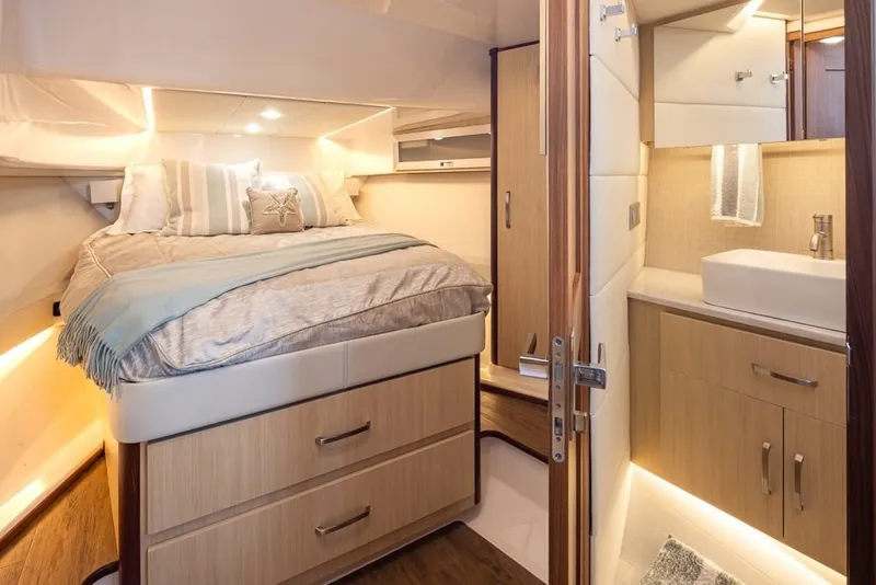 Slide: The Image of Luxurious interior of 2024 Regal 36 Grande Coupe yacht with cozy bedroom and modern bathroom. - 6