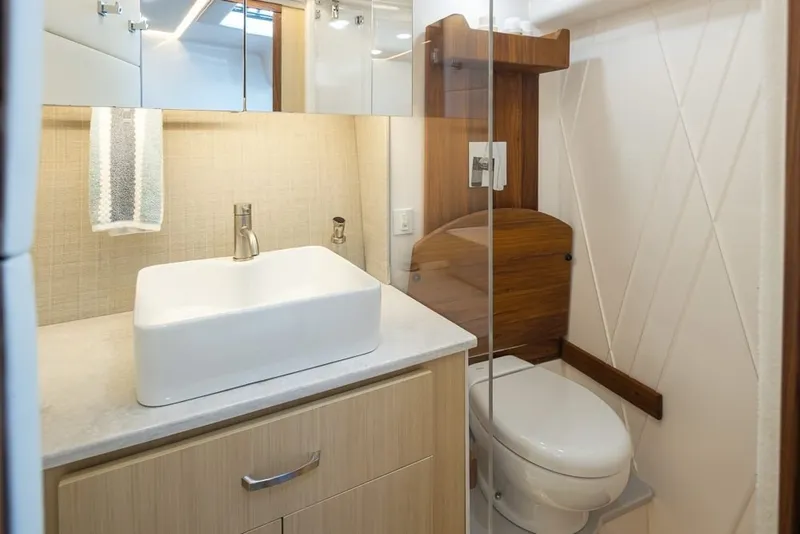 Slide: The Image of Luxurious bathroom in 2024 Regal 36 Grande Coupe yacht with modern sink and toilet. - 9