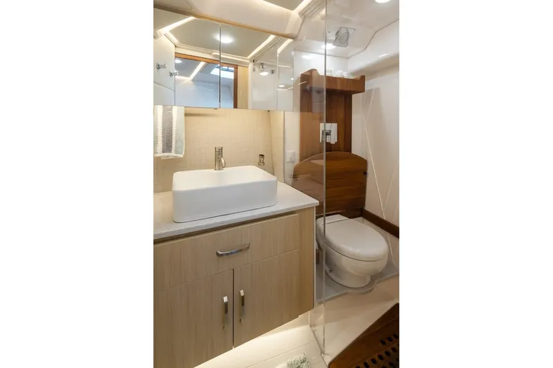 Slide: The Image of Luxurious bathroom in 2024 Regal 36 Grande Coupe yacht, featuring modern fixtures and elegant design. - 8