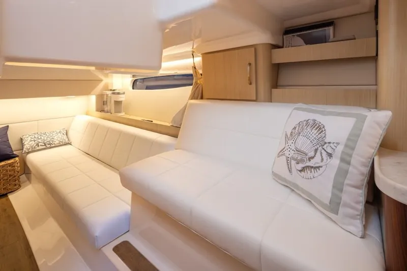 Slide: The Image of Luxurious interior of 2024 Regal 36 Grande Coupe with elegant seating and coastal decor. - 11
