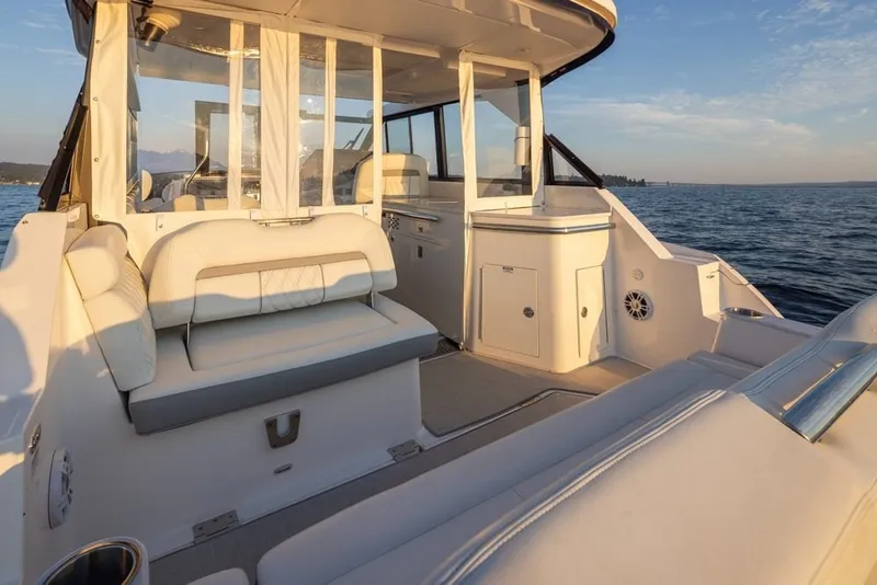 Slide: The Image of 2024 Regal 36 Grande Coupe luxury yacht interior with elegant seating and ocean view. - 16