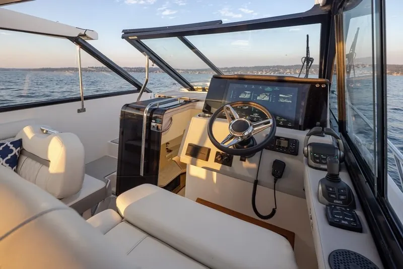 Slide: The Image of Interior view of 2024 Regal 36 Grande Coupe yacht cockpit with modern controls. - 14