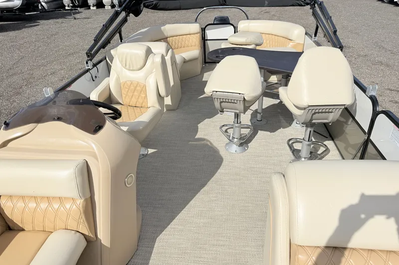 The Image of 2019 South Bay S224SB225 pontoon boat interior with beige seating and table. - 0