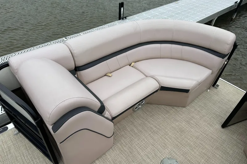 Slide: The Image of The image shows an elegant, cream-colored seating area on a boat docked by a pier. - 8