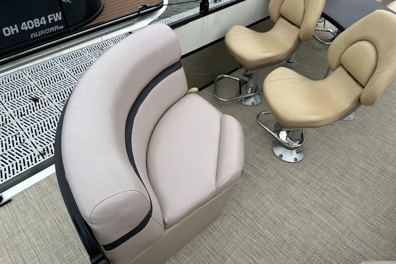 Slide: The Image of Interior of a South Bay pontoon boat with beige seating and carpeted floor. - 7