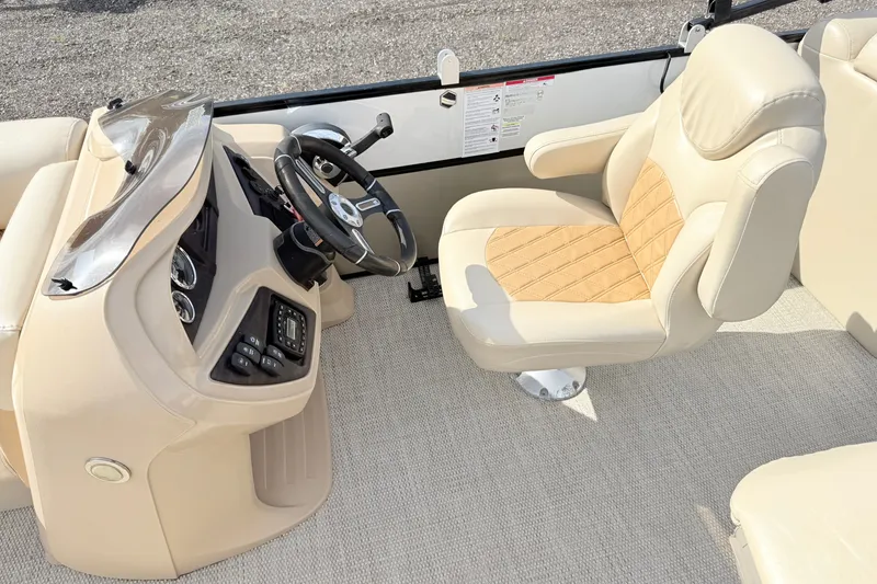 Slide: The Image of Luxurious 2019 South Bay S224SB225 boat interior with beige captain's chair and steering console. - 6