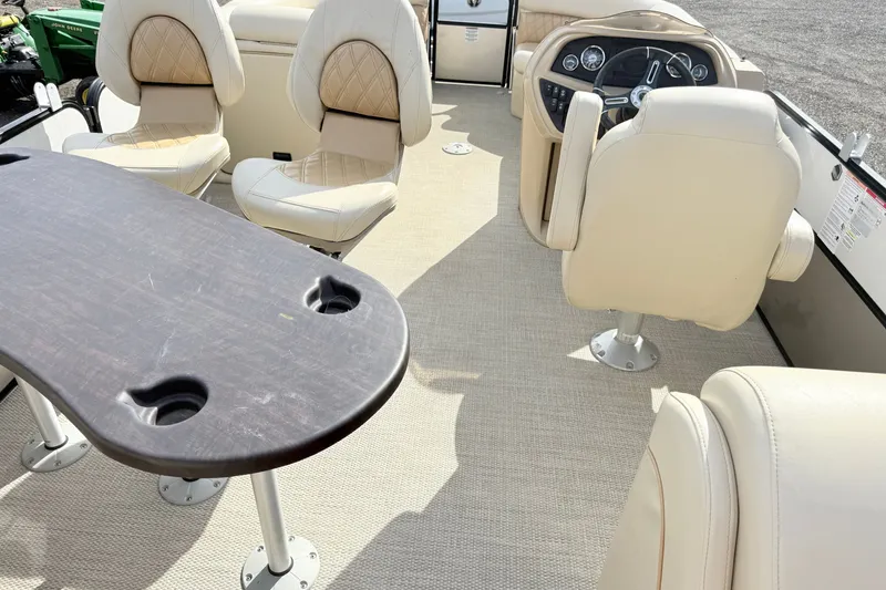 Slide: The Image of Interior of a 2019 South Bay S224SB225 pontoon boat with beige seating and table. - 11