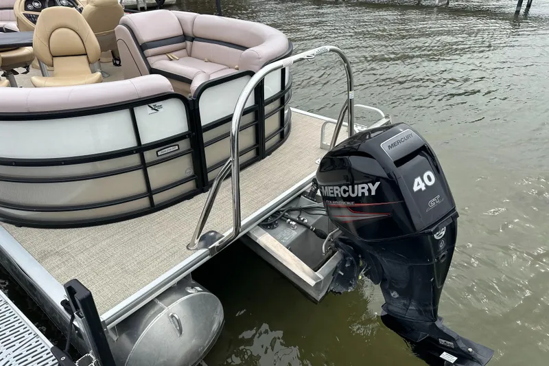 Slide: The Image of A 2019 South Bay pontoon boat with a Mercury 40 HP outboard motor on calm water. - 5