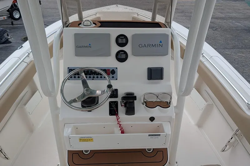 Slide: The Image of 2019 Key West 239 FS boat console with Garmin navigation system and steering wheel. - 11