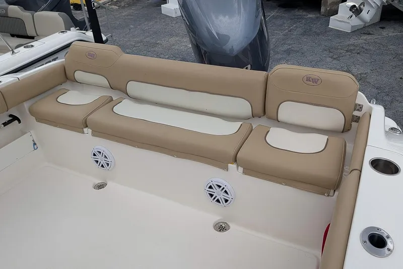 Slide: The Image of 2019 Key West 239 FS boat interior with beige seating and built-in speakers. - 7