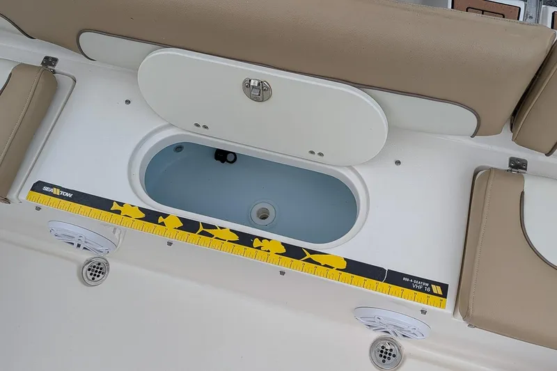 Slide: The Image of 2019 Key West 239 FS boat interior with storage compartment and measuring ruler. - 8