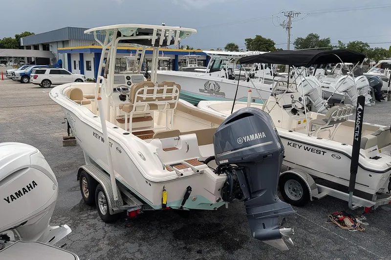 Slide: The Image of 2019 Key West 239 FS boat with Yamaha engine on trailer in dealership lot. - 2