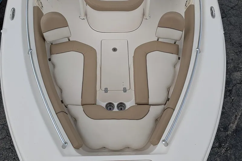 Slide: The Image of 2019 Key West 239 FS boat interior with beige seating and storage compartment. - 17