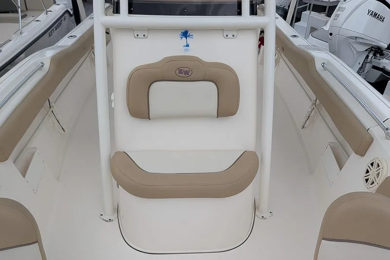 Slide: The Image of 2019 Key West 239 FS boat interior with beige seating and Yamaha engine. - 15