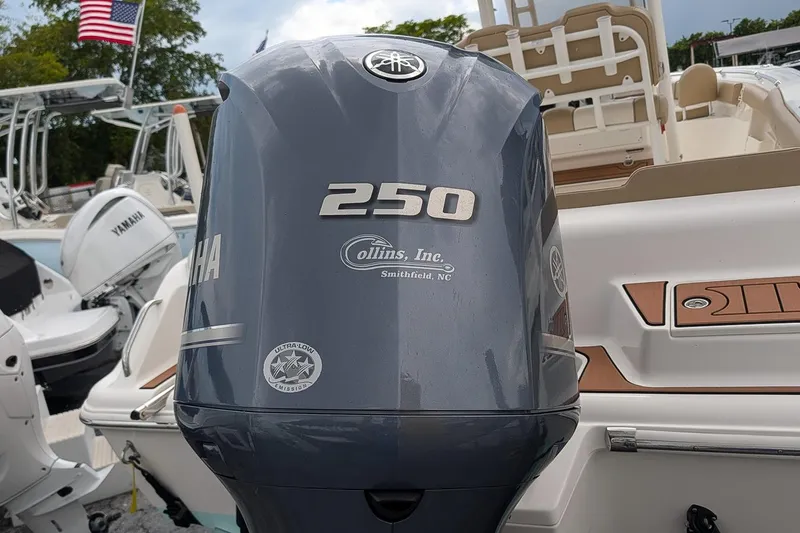 Slide: The Image of 2019 Key West 239 FS boat with Yamaha 250 outboard motor, docked with American flag. - 4