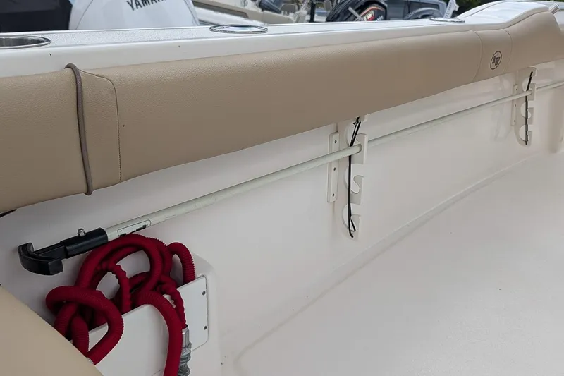 Slide: The Image of 2019 Key West 239 FS boat interior with beige seating and red rope storage. - 13
