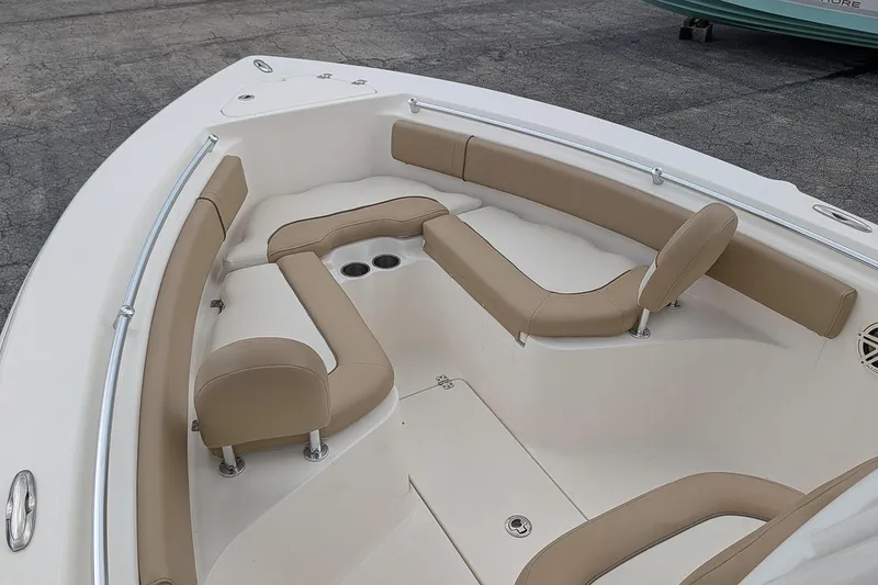 Slide: The Image of 2019 Key West 239 FS boat interior with tan cushioned seating and cup holders. - 16