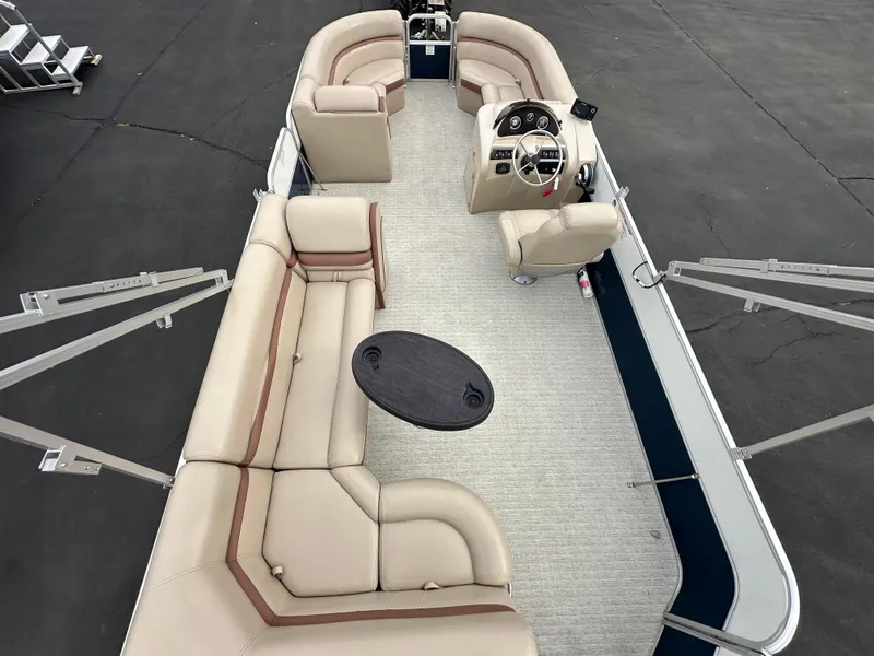Slide: The Image of 2018 South Bay S224CR pontoon boat with beige seating and steering wheel. - 15
