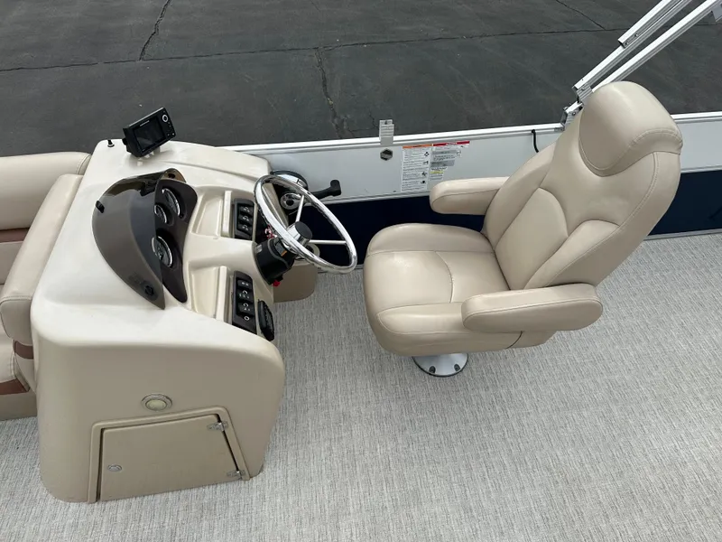 Slide: The Image of The image shows the helm of a 2018 South Bay S224CR boat with a beige captain's chair. - 9