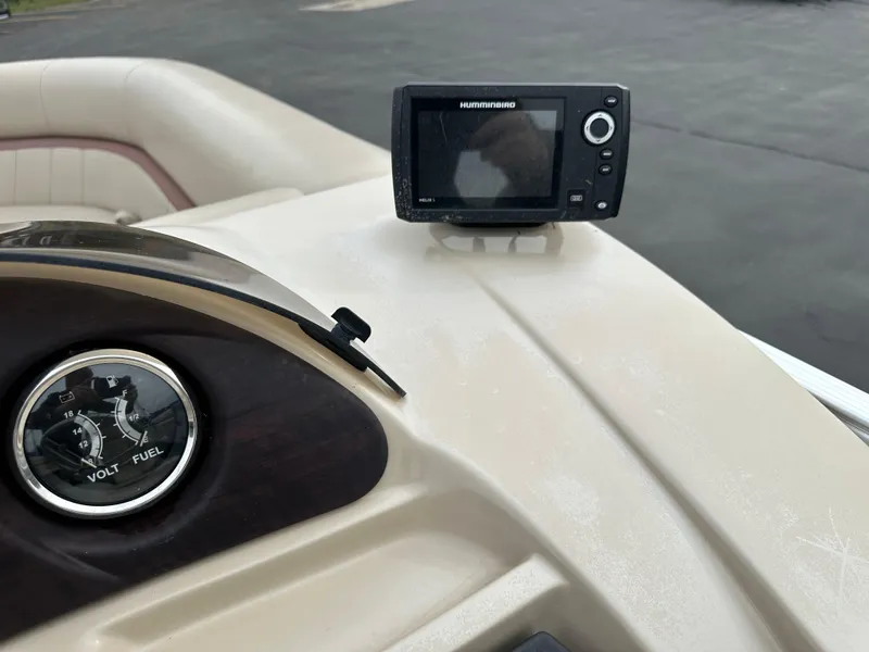 Slide: The Image of Close-up of a boat dashboard with a Humminbird fish finder and a voltmeter. - 11