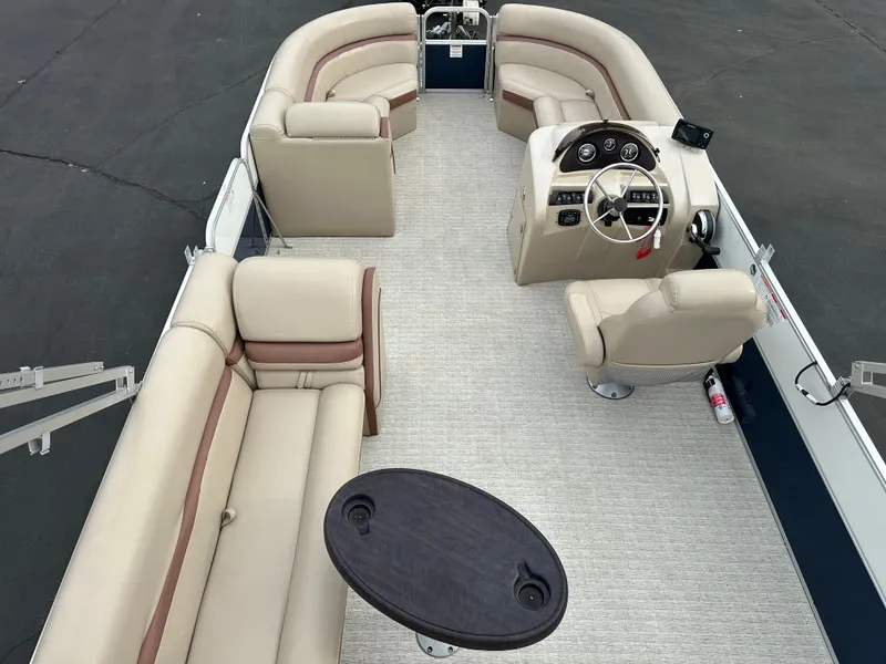Slide: The Image of Interior view of a 2018 South Bay S224CR pontoon boat with beige seating and a table. - 14