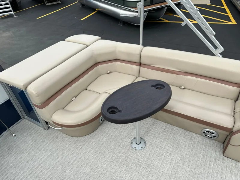 Slide: The Image of The image shows a beige corner bench with a round table on a boat. - 13