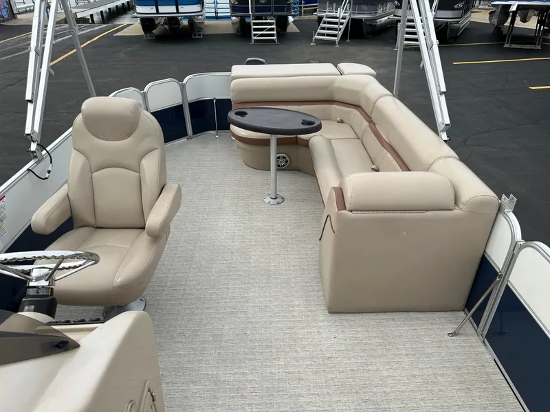 Slide: The Image of The image shows the interior of a 2018 South Bay S224CR pontoon boat with beige seating. - 8
