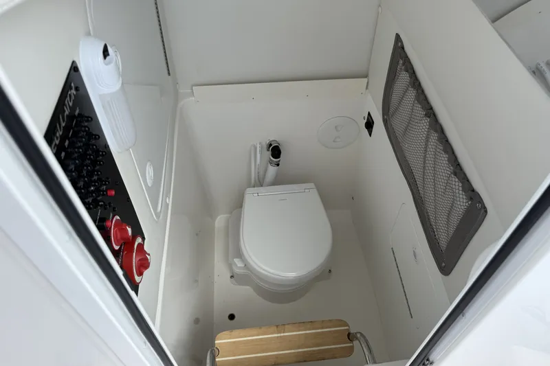Slide: The Image of 2026 Regulator 25 boat interior with toilet and control panel. - 14