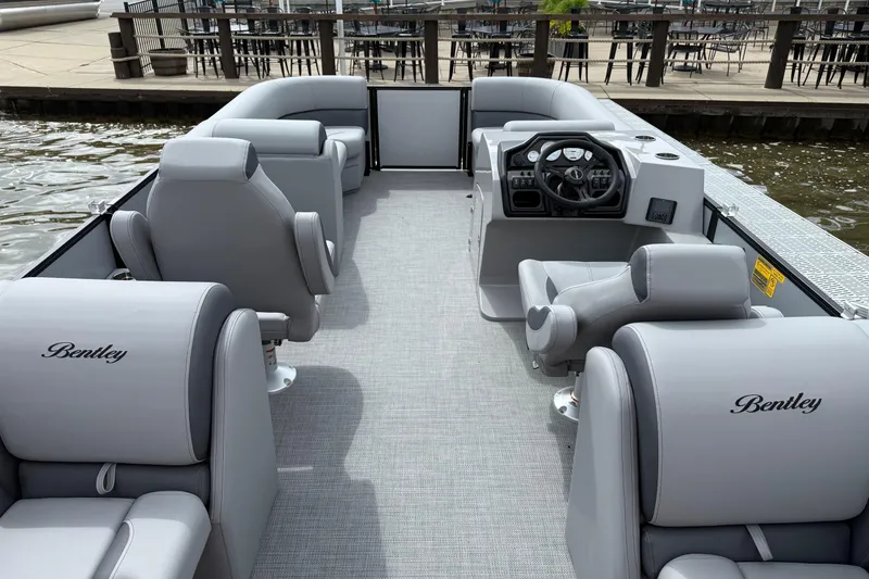 Slide: The Image of 2026 Bentley Pontoons Legacy 220 Navigator with luxurious seating and modern helm. - 10