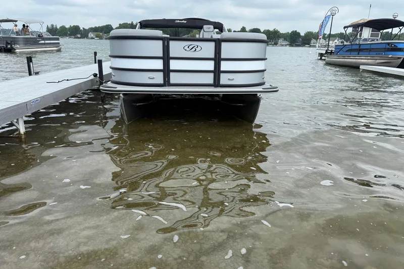 Slide: The Image of 2026 Bentley Pontoons Legacy 220 Navigator docked on a calm lake. - 2