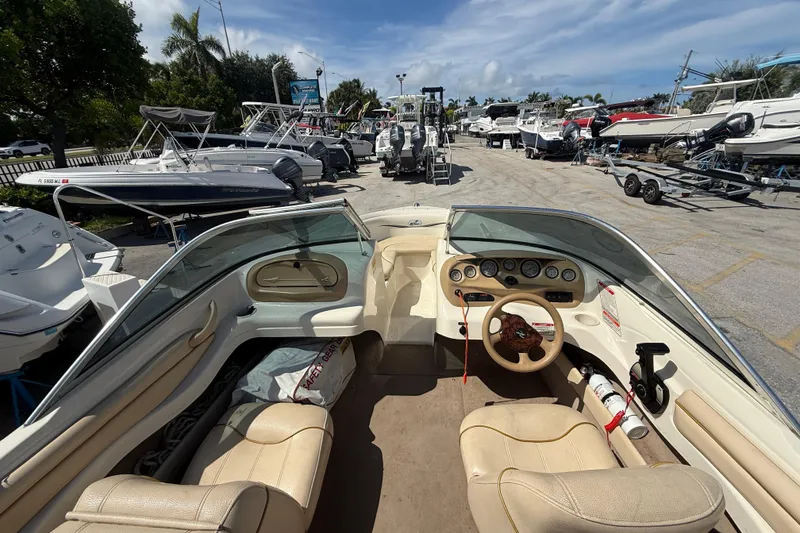 Slide: The Image of Interior view of a 2001 Sea Ray 180 Bow Rider boat at a marina. - 11