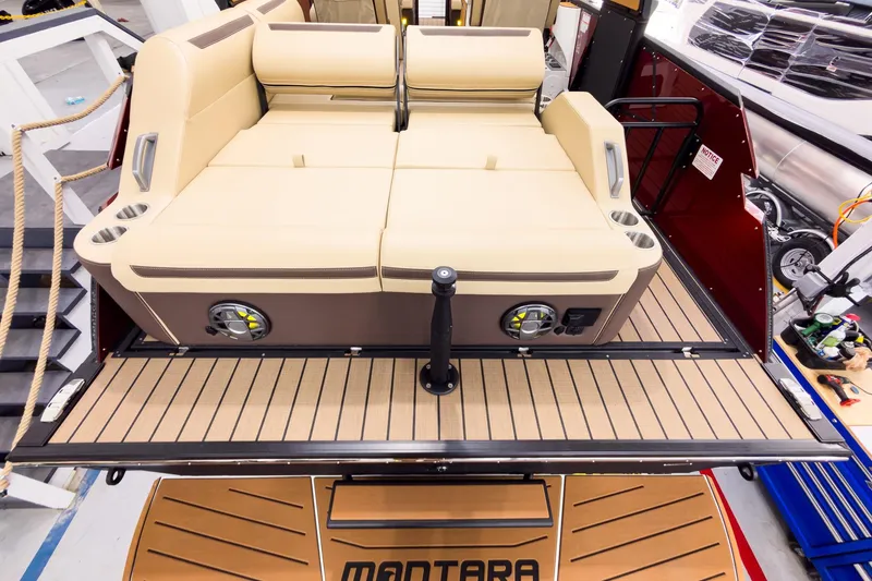 Slide: The Image of Luxurious seating on 2026 Montara Surf Boss EVO - SL 25' boat, featuring cup holders and speakers. - 27