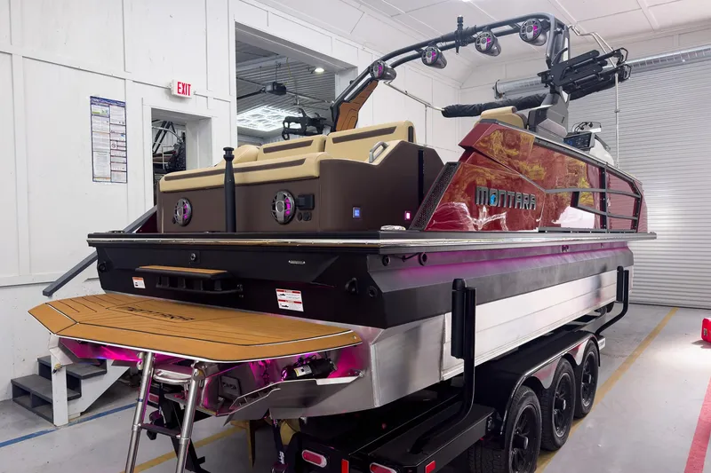 Slide: The Image of 2026 Montara Surf Boss EVO - SL 25' boat in a showroom, rear view. - 4