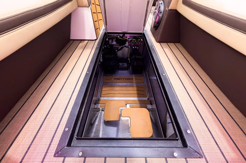 Slide: The Image of 2026 Montara Surf Boss EVO SL 25' interior with open engine compartment, showcasing sleek design. - 12