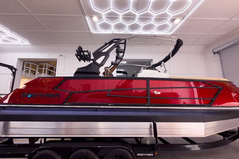 Slide: The Image of 2026 Montara Surf Boss EVO - SL 25' boat in showroom, featuring sleek red design. - 6
