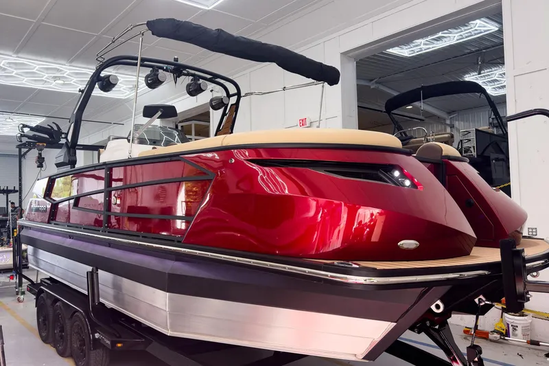 Slide: The Image of 2026 Montara Surf Boss EVO - SL 25' boat in showroom, featuring sleek red design and modern amenities. - 7