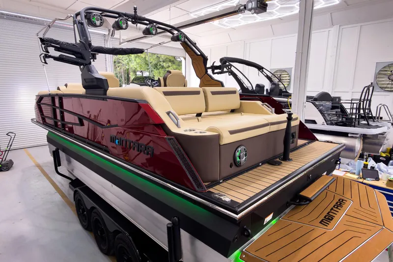 Slide: The Image of 2026 Montara Surf Boss EVO - SL 25' luxury boat in showroom, featuring sleek design and modern amenities. - 2
