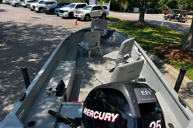 Slide: The Image of 2012 Alumacraft Fisherman 160 Tiller boat with Mercury EFI engine in parking lot. - 4